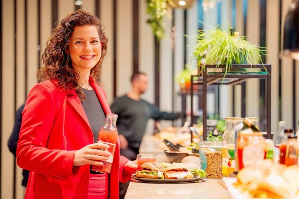 An employee smiling in the canteen, reflecting the social and inclusive values of B Corp