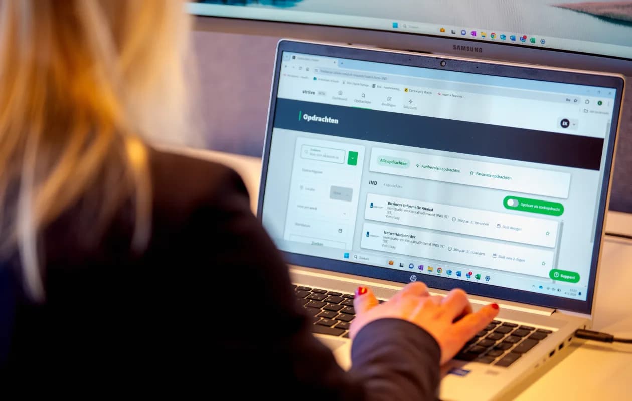 Person on laptop searching for assignments via Striive