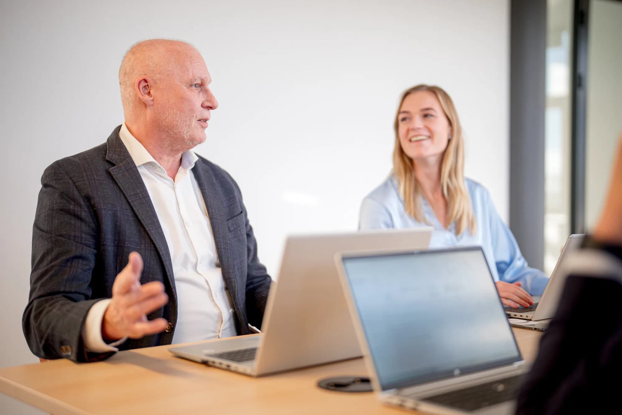 Two people laughing during a meeting at the office